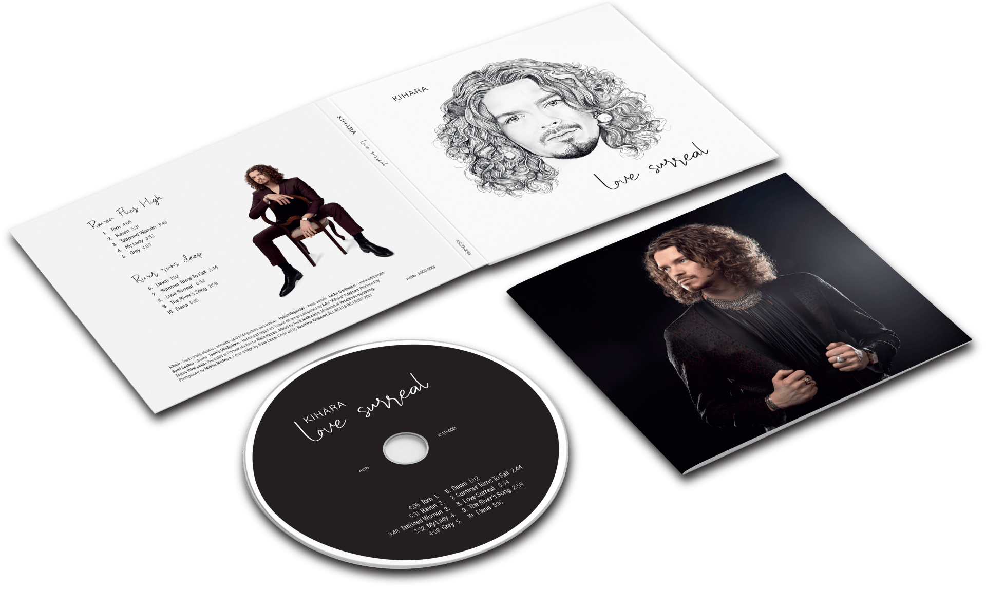 Kihara, Love Surreal CD-levy avonaisena yhdessä levyn ja bookletin kanssa valkoisella pöydällä.