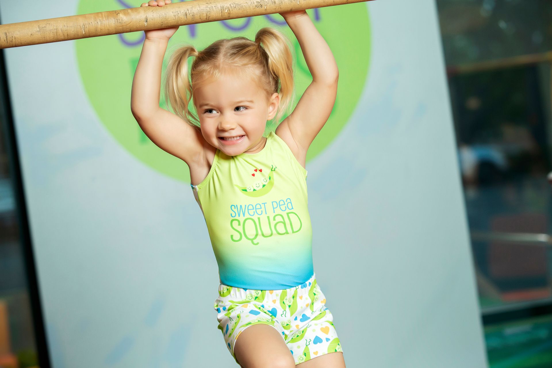 Preschool Gymnast Hanging on a bar at Sweet Peas in Irving texas