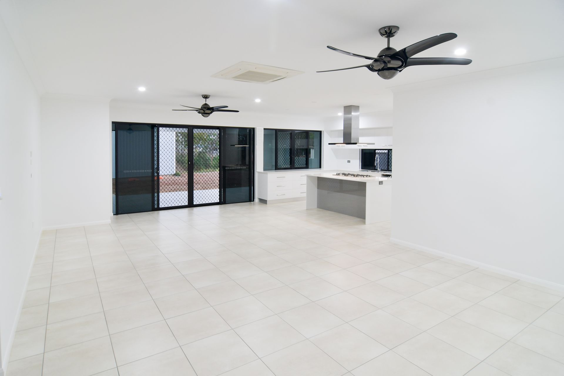 Empty, Bright Living Area With Open Kitchen — B & C Cabinets in Mareeba, QLD