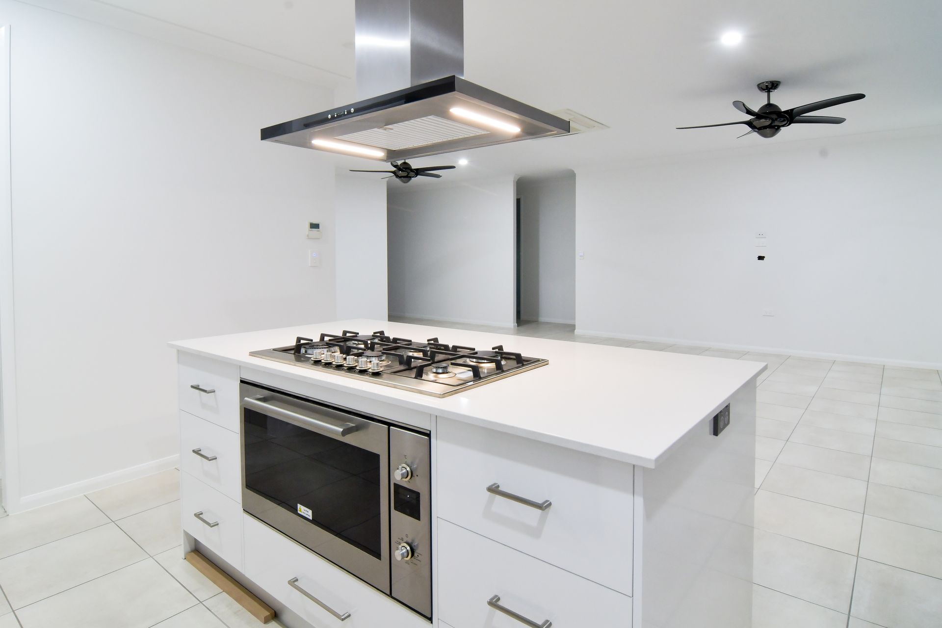 White Kitchen Island With Gas Cooktop and Oven — B & C Cabinets in Mareeba, QLD