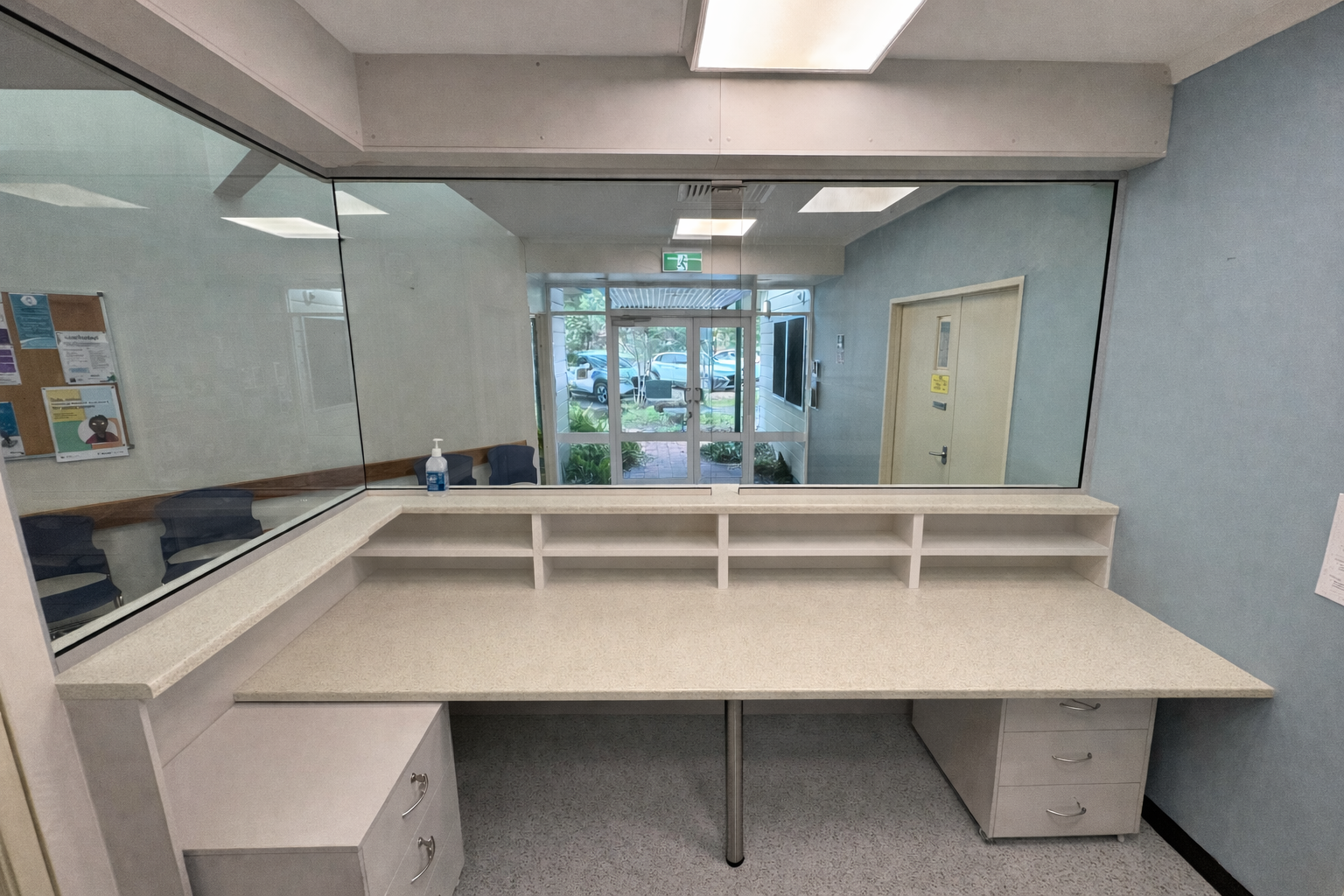 L-shaped Reception Desk With A Large Window, A View Of An Entrance, And Filing Cabinets — B & C Cabinets in Mareeba, QLD