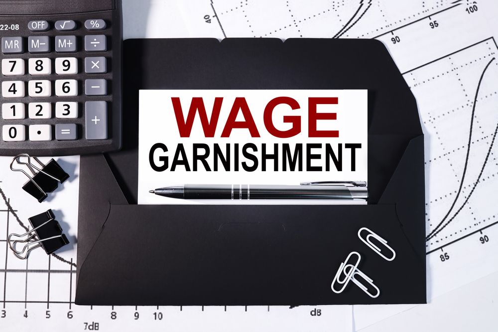 A black envelope with the words wage garnishment written on it