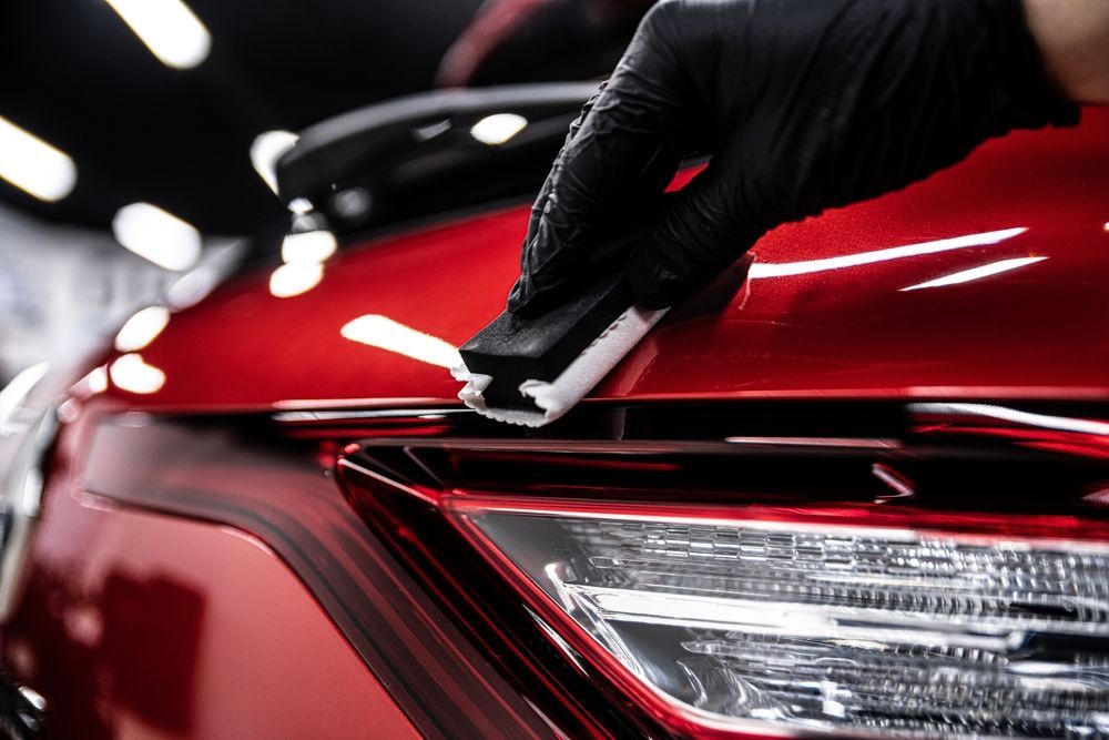 A Gloved Hand Uses a Foam Applicator Block — Best Car Detailing in Vincent, QLD