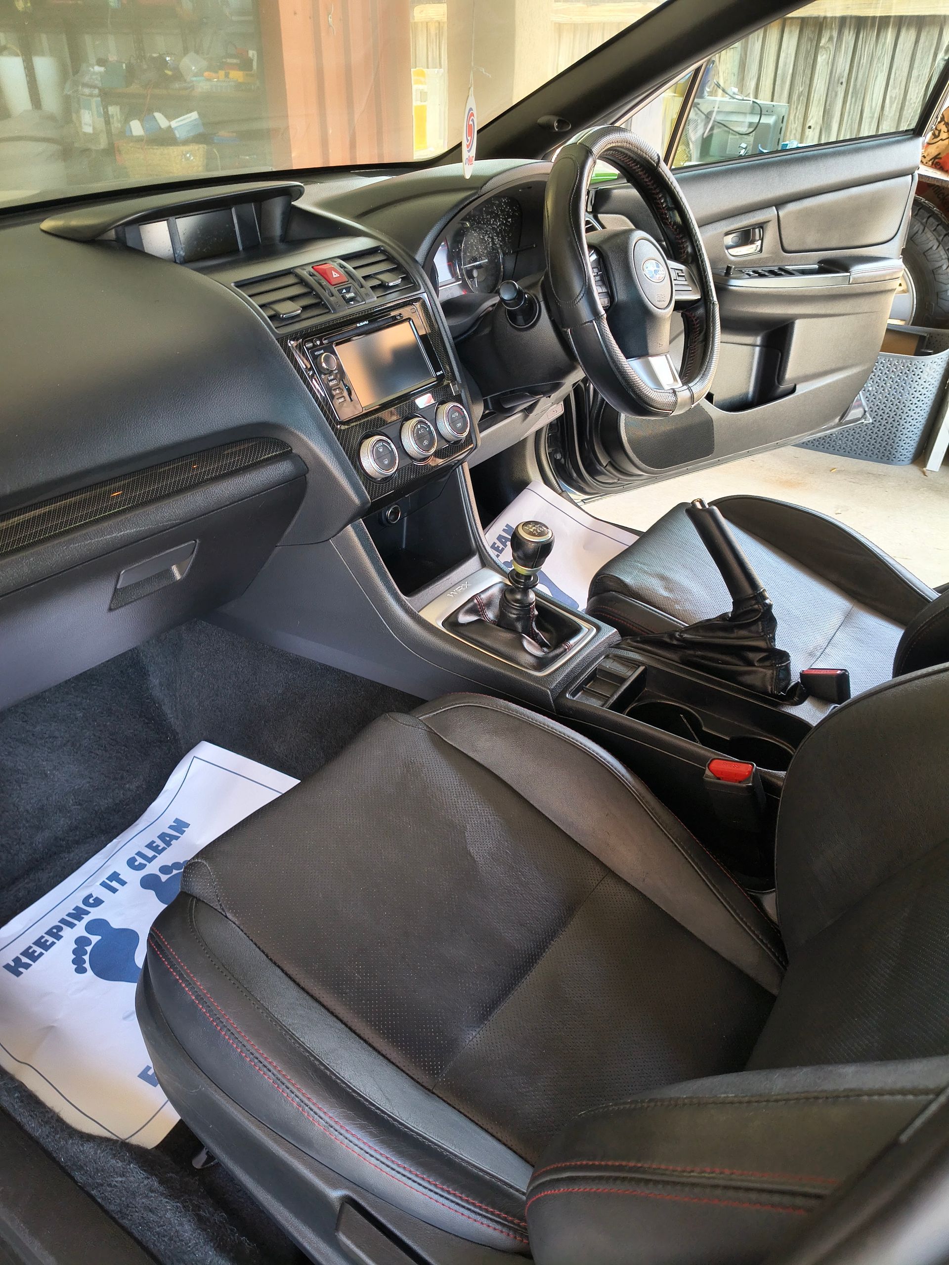 Interior View Of A Car With Black Seats, Dashboard, And Steering Wheel; A Manual Gear Shift Is Visible — Best Car Detailing in Vincent, QLD