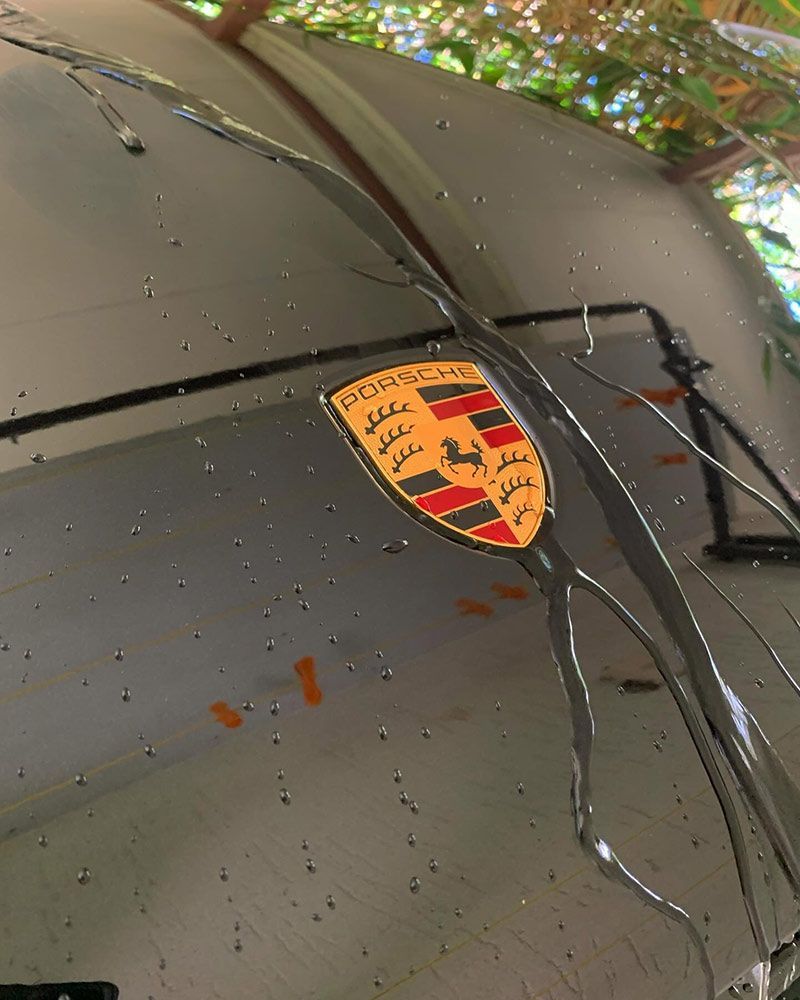 A Porsche Emblem is on the Windshield of a Car — Best Car Detailing in Vincent, QLD