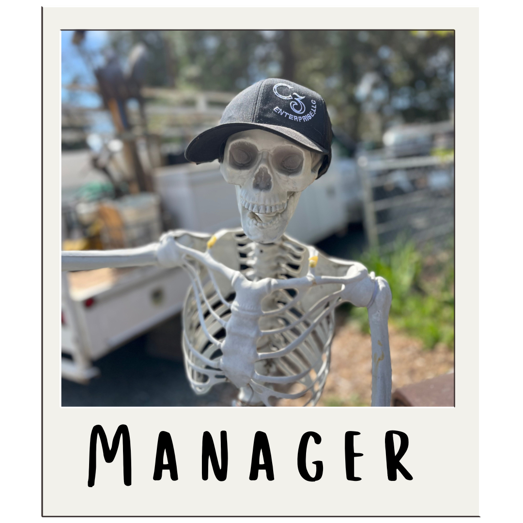 A skeleton wearing a hat with the word manager below it
