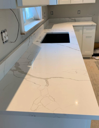 A kitchen with a large counter top and a sink.