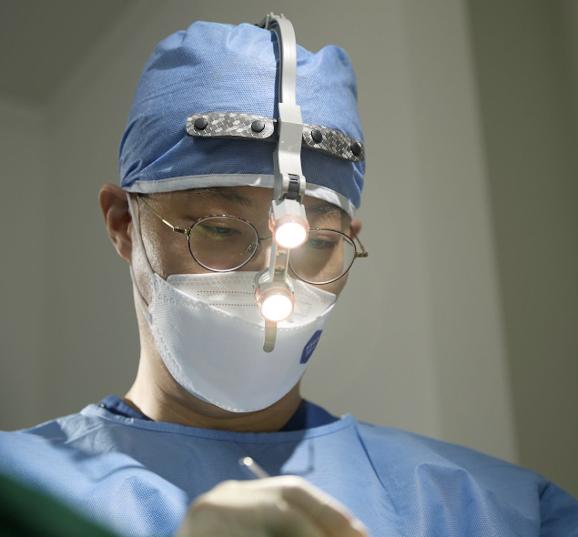Dr. Kim during surgery with surgical loupes