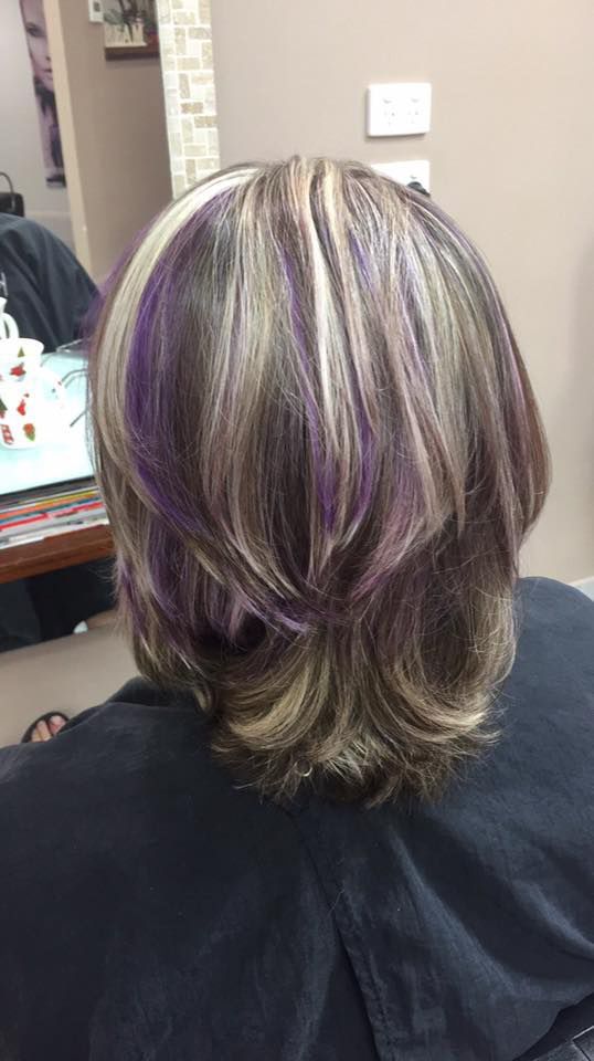 A Woman With Purple Highlights in Her Hair is Sitting in Front of a Mirror — Instyle Hair on B in Berserker, QLD