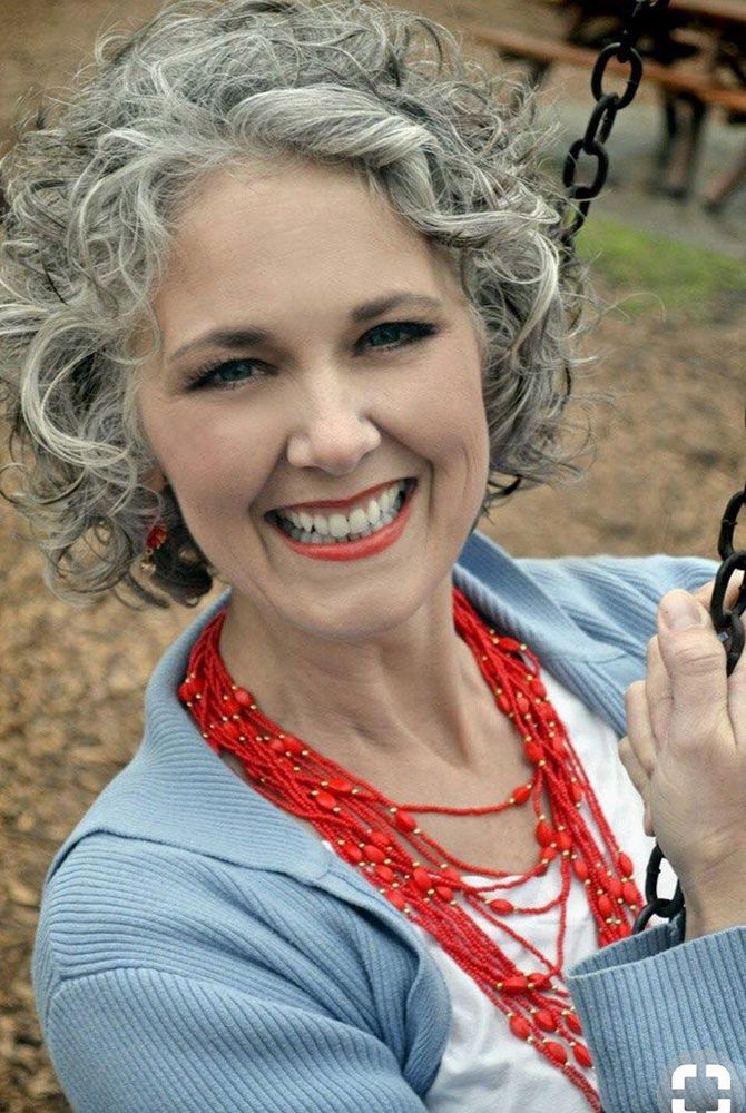 A Woman With Gray Hair is Smiling While Sitting on a Swing — Instyle Hair on B in Berserker, QLD