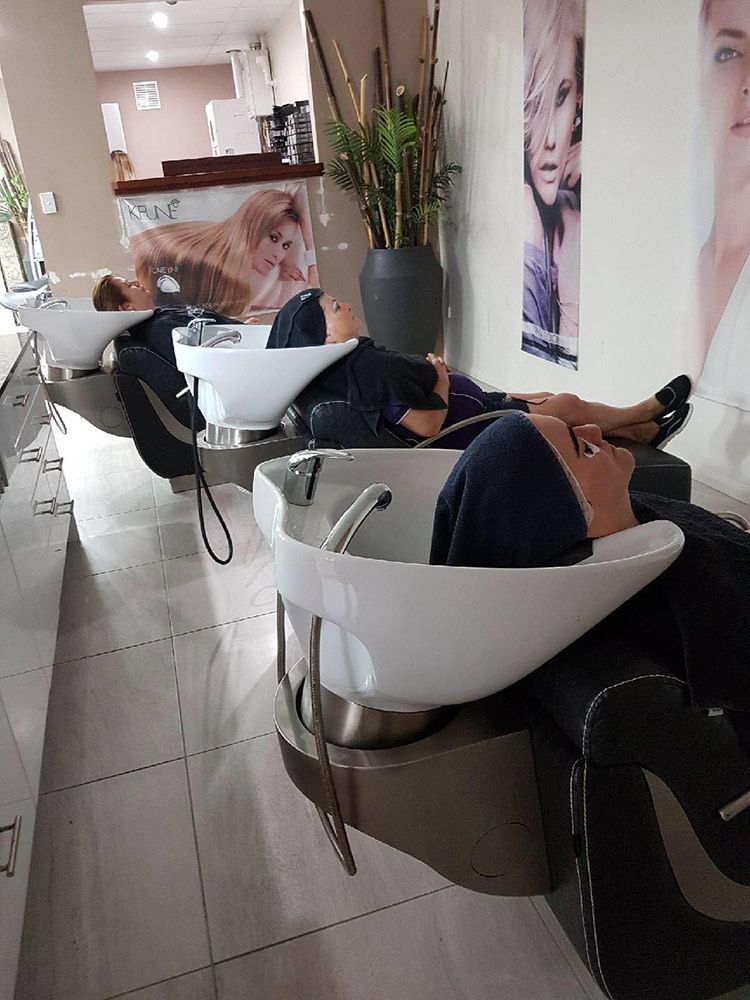 A Woman is Laying in a Hair Salon Getting Her Hair Washed — Instyle Hair on B in Berserker, QLD