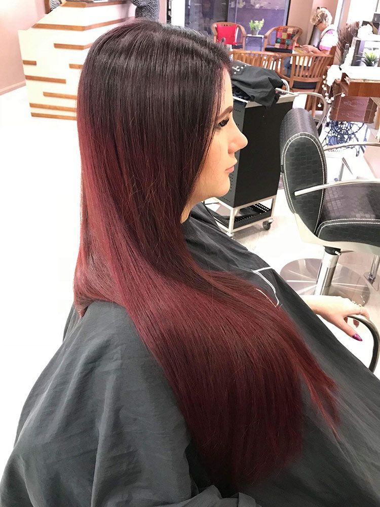 A Woman With Long Red Hair is Getting Her Hair Cut in a Salon — Instyle Hair on B in Berserker, QLD