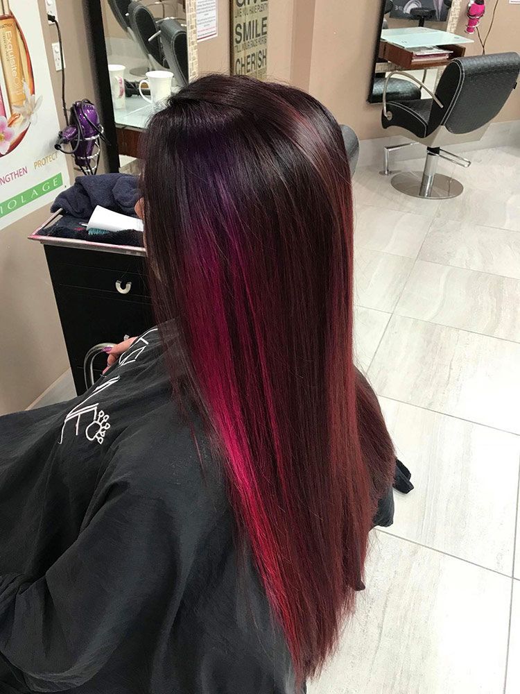 A Woman With Long Red Hair is Sitting in a Hair Salon — Instyle Hair on B in Berserker, QLD
