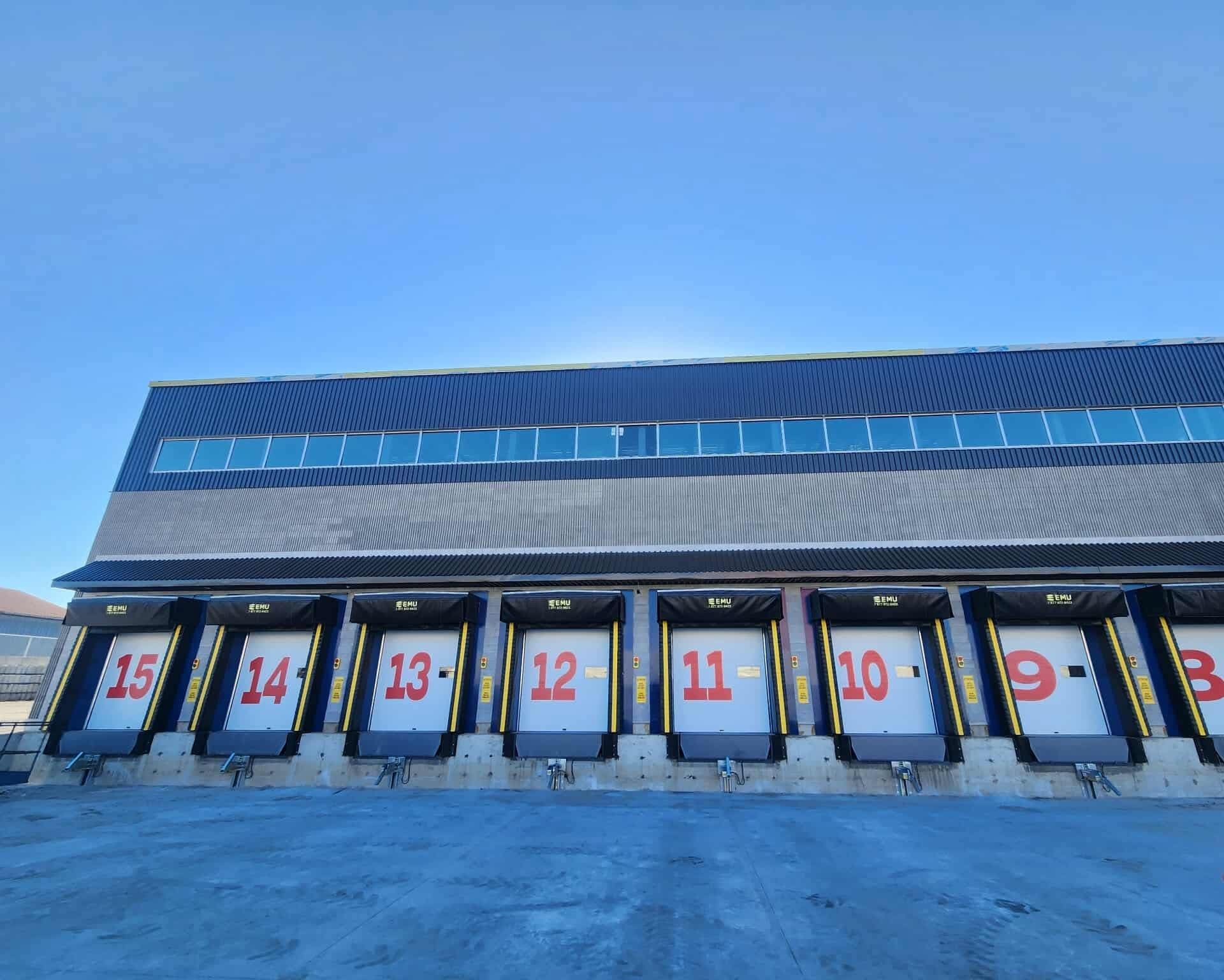 Snowy rooftop with large numbered skylights under a clear blue sky