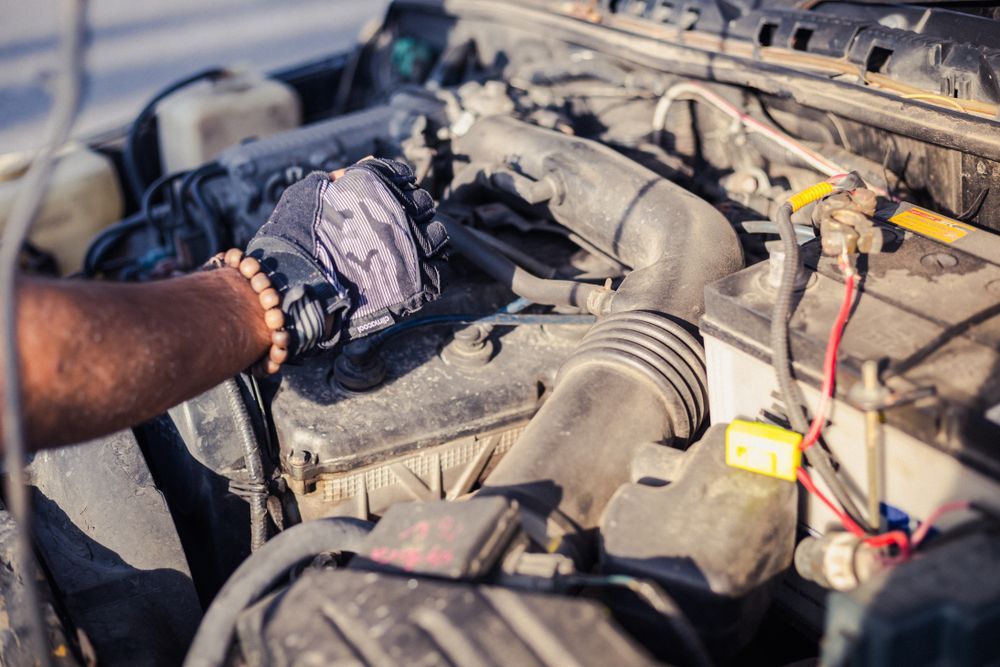 Car Mechanic Working Under Car Hood