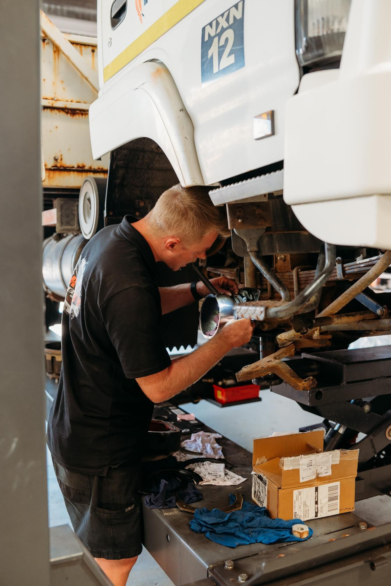 Man fixing vehicle— Signature Mechanical In South Gladstone, QLD