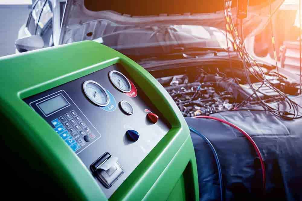A Green Machine Is Sitting On Top Of A Car With The Hood Open — Signature Mechanical In South Gladstone, QLD