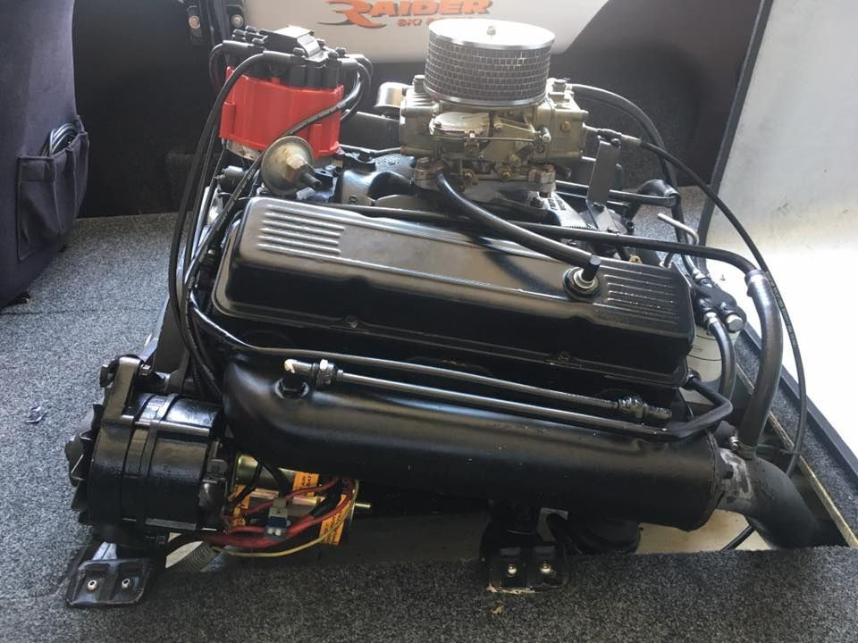 A Black Engine Is Sitting On The Bottom Of A Boat — Signature Mechanical In South Gladstone, QLD