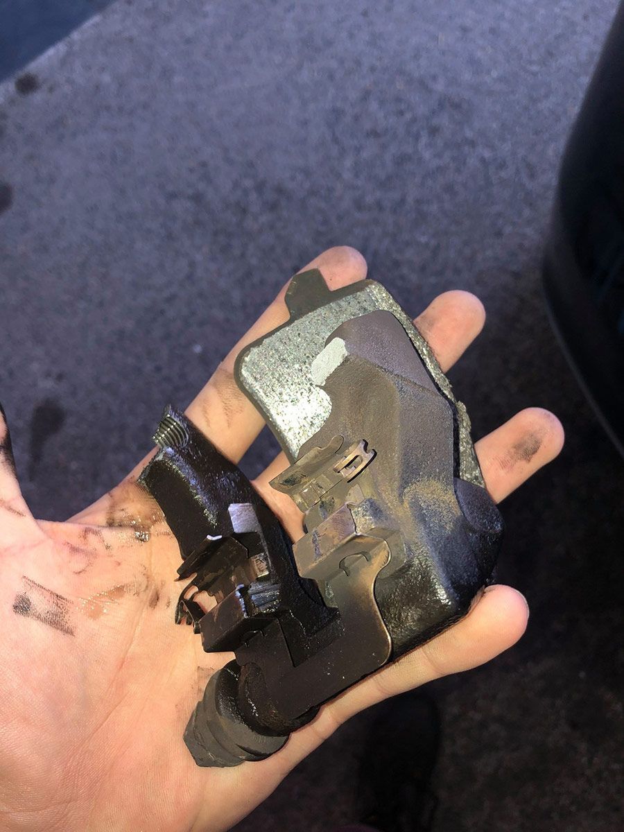 A Person Is Holding A Piece Of Metal In Their Hand — Signature Mechanical In South Gladstone, QLD