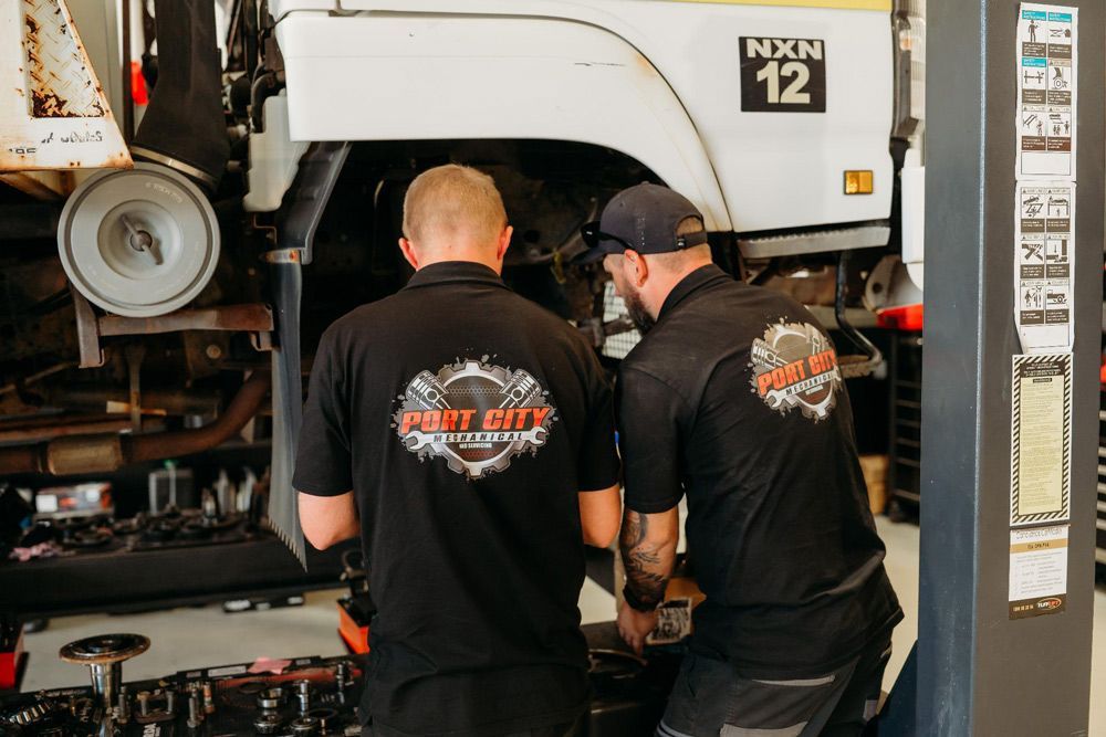 Mobile Mechanics Doing Maintenance on A Vehicle