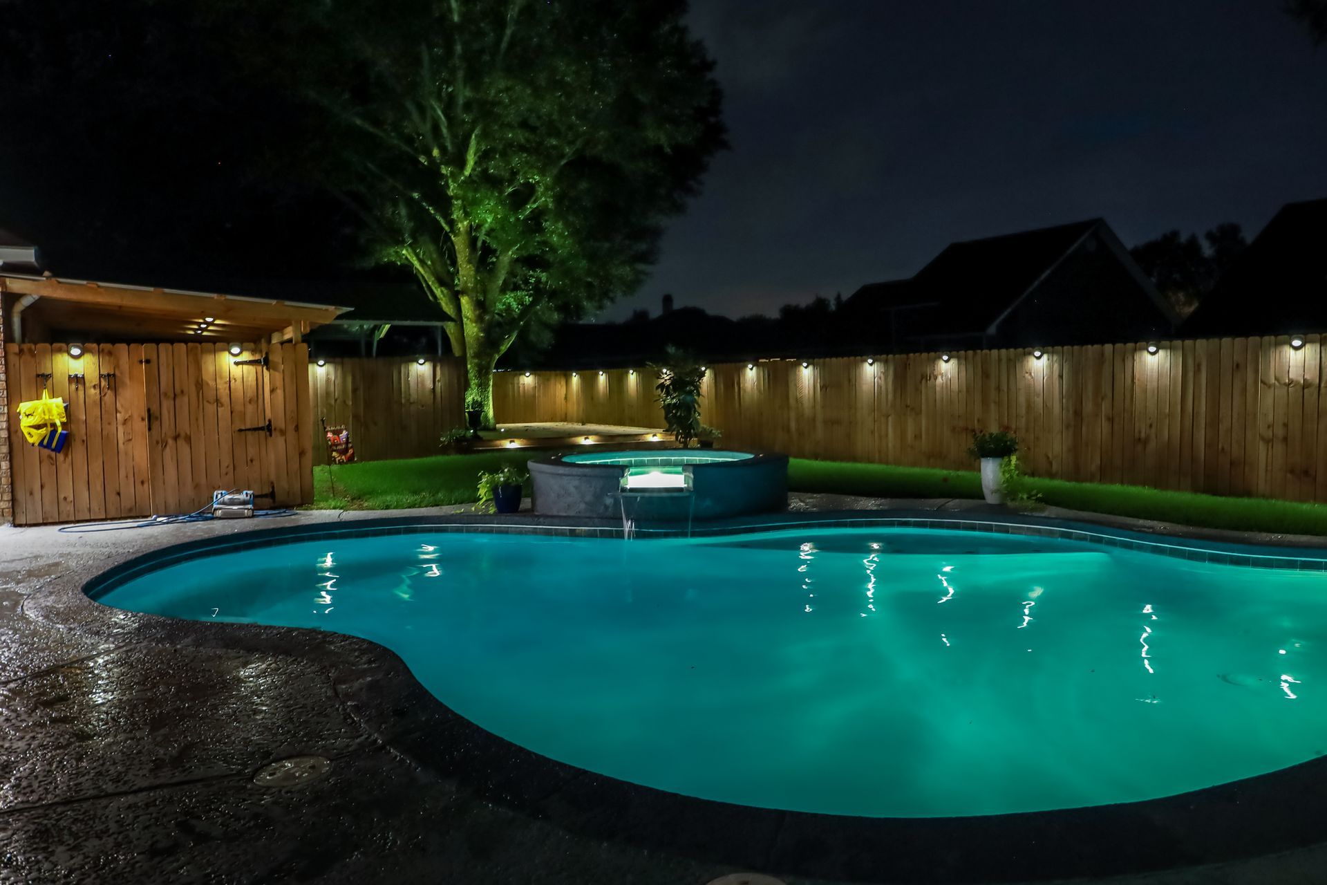 A Large Swimming Pool Is Lit up At Night in A Backyard - Provo UT - Spa Doctor