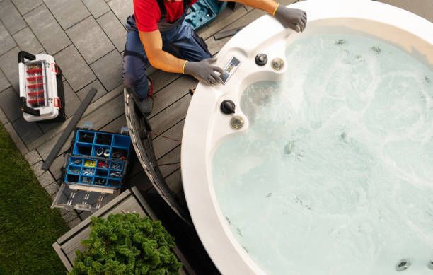 A Man Is Working on A Hot Tub on A Deck - Provo UT - Spa Doctor
