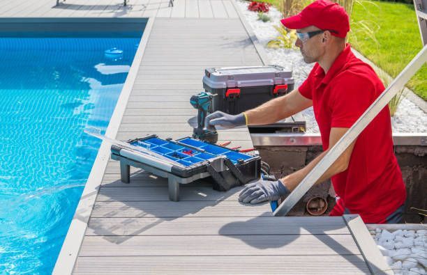 A Man in A Red Shirt Is Working on A Swimming Pool - Provo UT - Spa Doctor