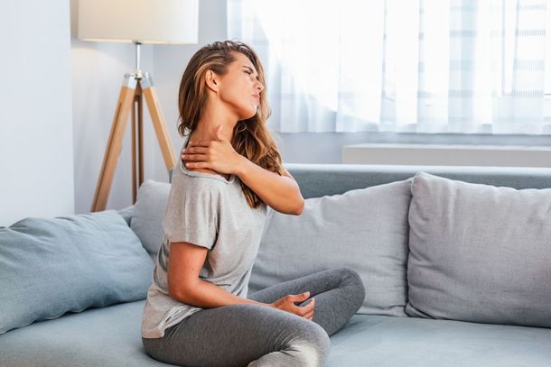 Person receiving a back massage from a therapist in a bright clinic room