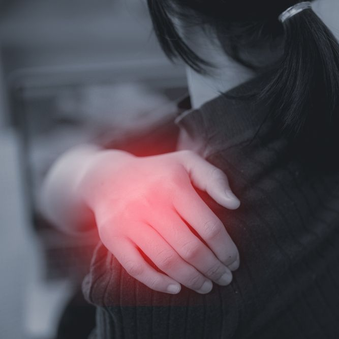 Person holding another’s shoulder, with a red glow highlighting a comforting touch.