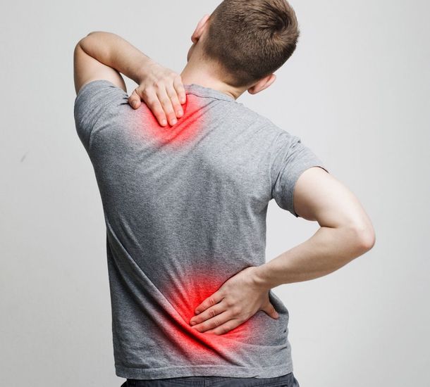 Person receiving a back massage from a therapist in a bright clinic room
