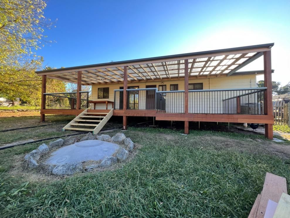 House With Deck and Fire Pit in Yard — J&C Quality Construction in Goulburn, NSW