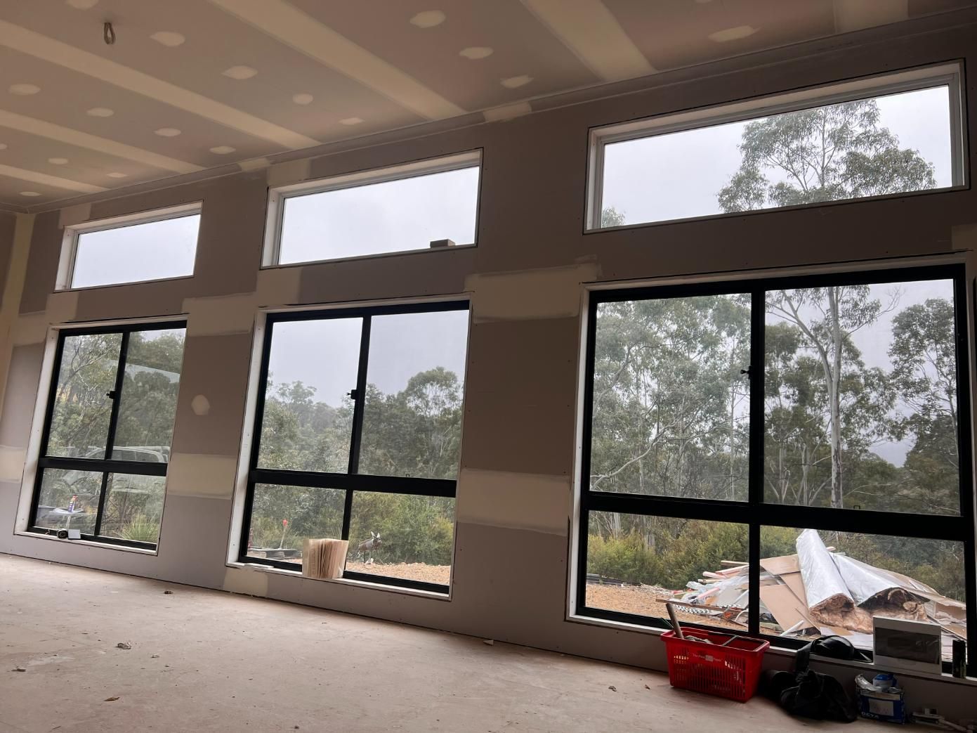 Interior of a Room Under Construction With Windows and Drywall — J&C Quality Construction in Goulburn, NSW