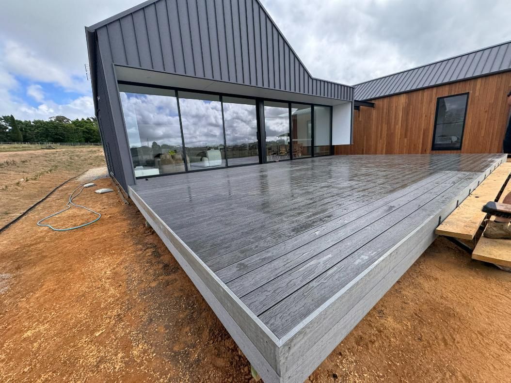 Modern House With Grey Deck and Glass Wall — J&C Quality Construction in Southern Highlands, NSW