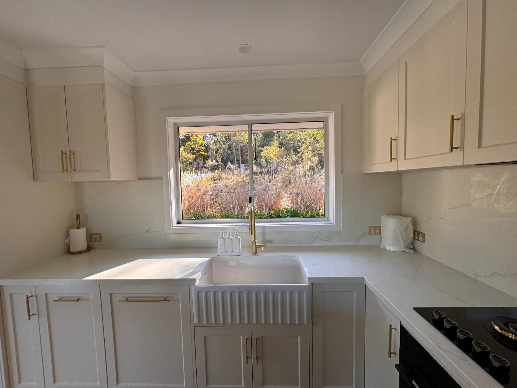 White Kitchen With Sink Under Window — J&C Quality Construction in Goulburn, NSW