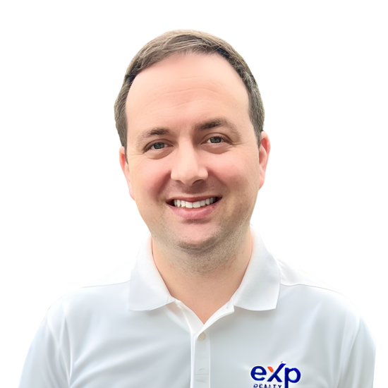 Man with dark hair, smiling, wearing a white polo shirt with 