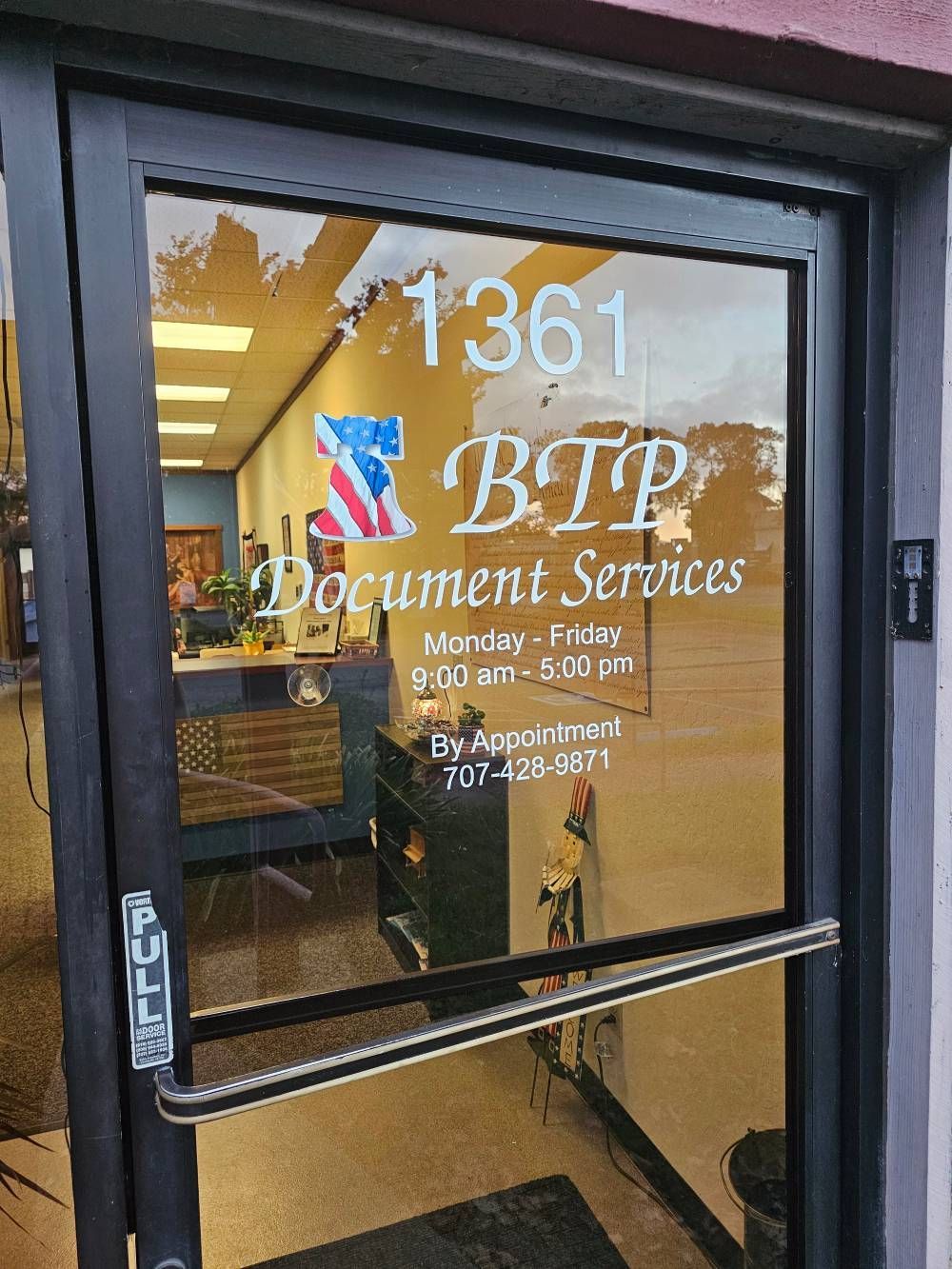 Glass door with gold lettering for BTP Document Services at 1361, showing an office interior inside.