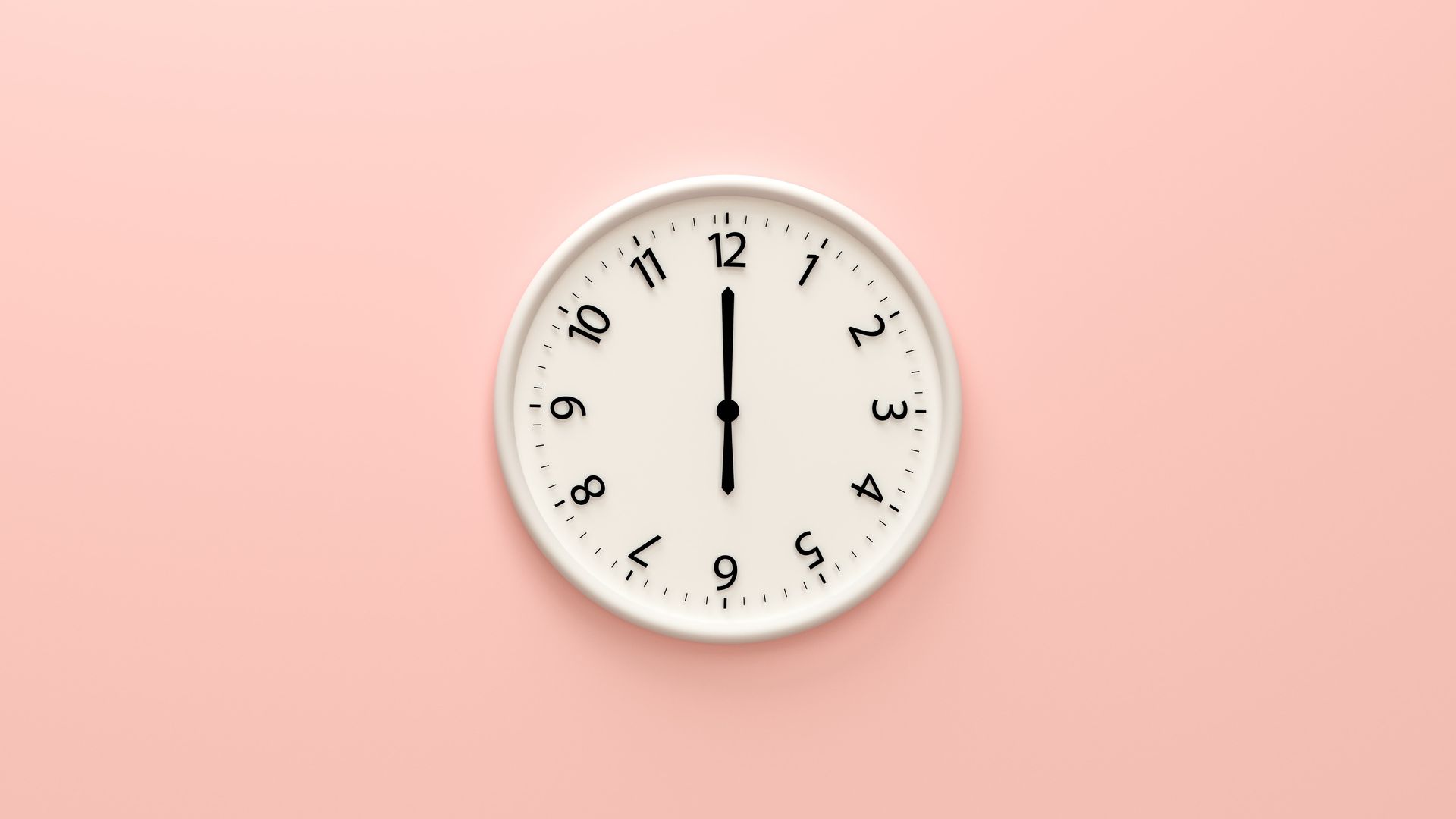 White wall clock on a pink background, showing 12:00.
