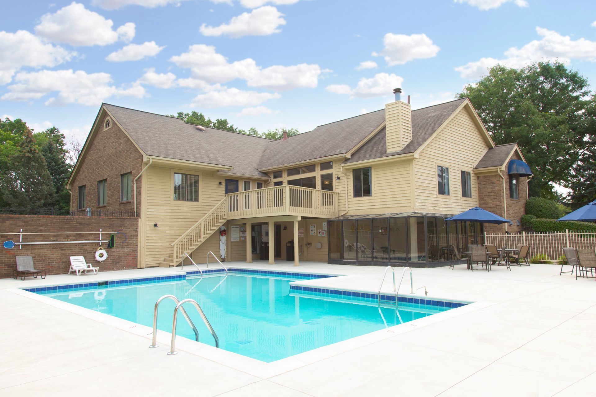 A large house with a large swimming pool in front of it