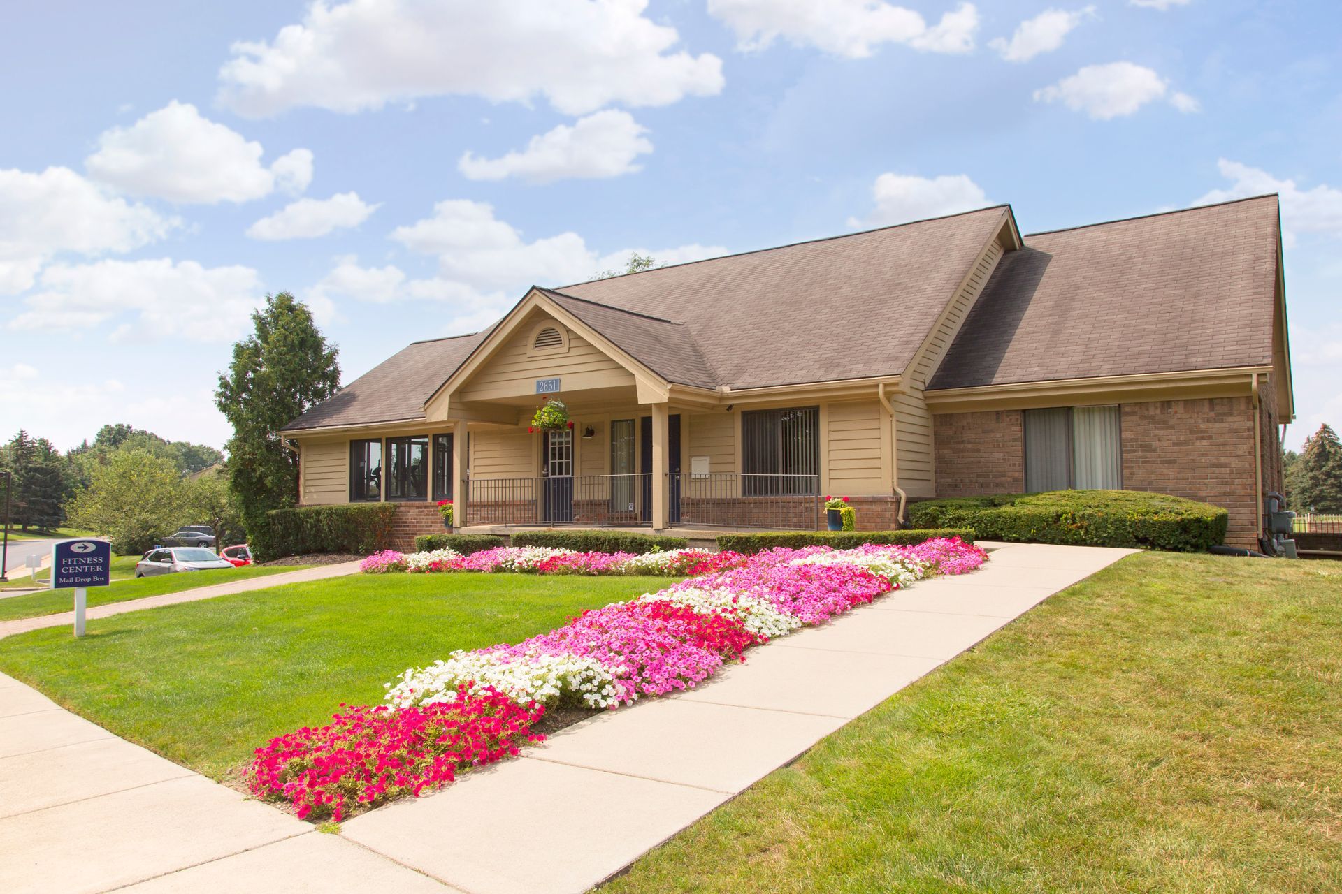 A brick house with flowers in front of it