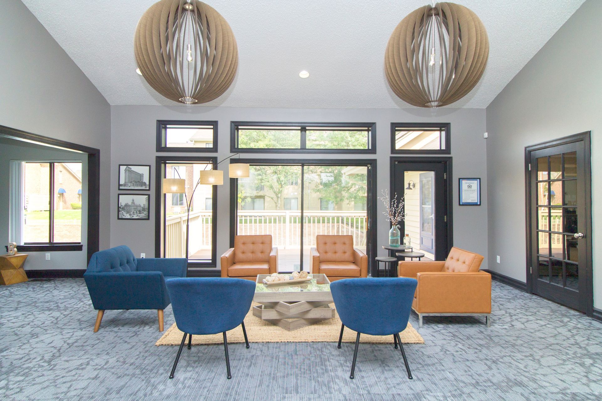 A living room with a lot of furniture and a large window.