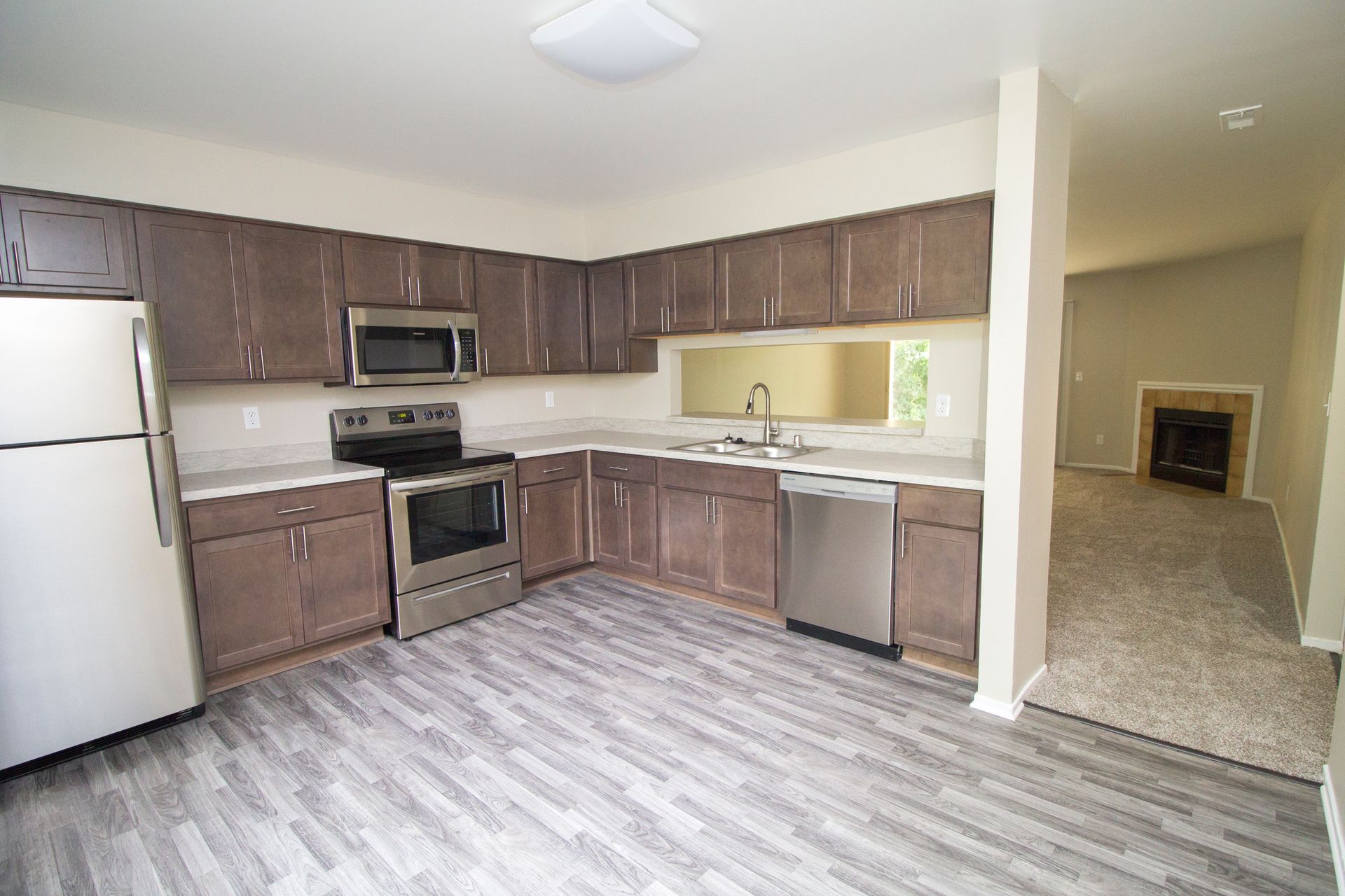 A kitchen with stainless steel appliances and wooden cabinets
