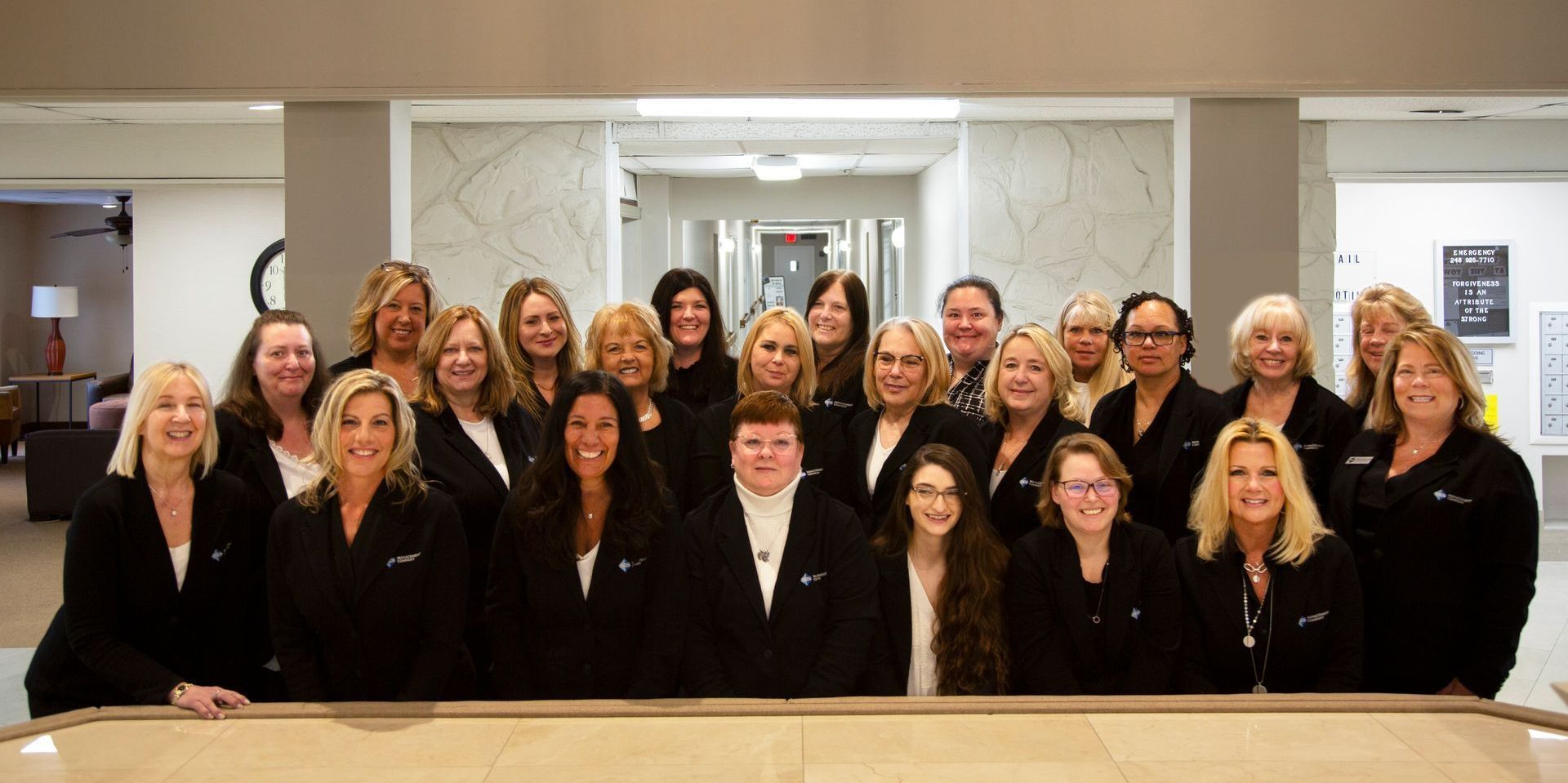 A group of women are posing for a picture in a room.