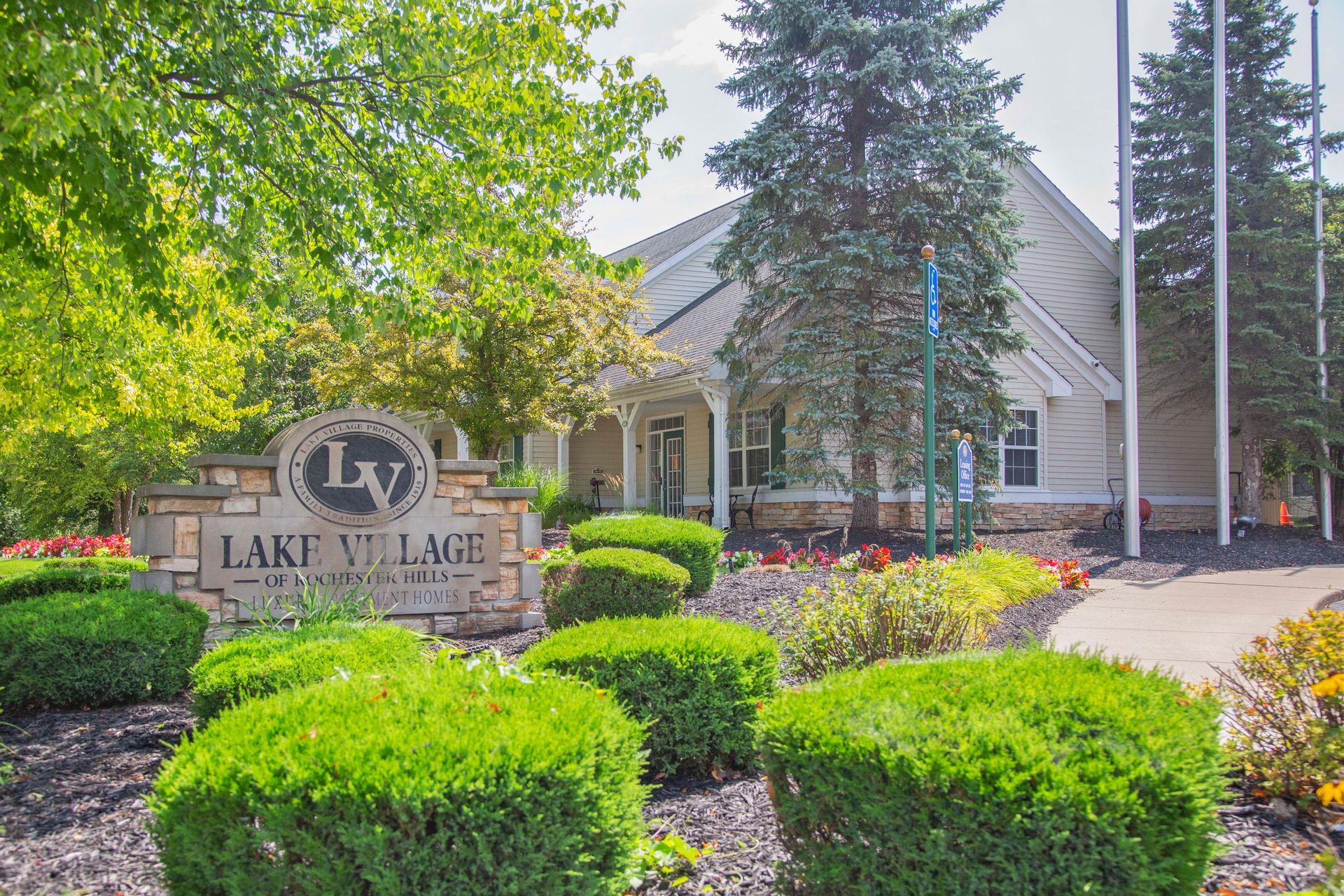A large building with a sign in front of it that says lake village.