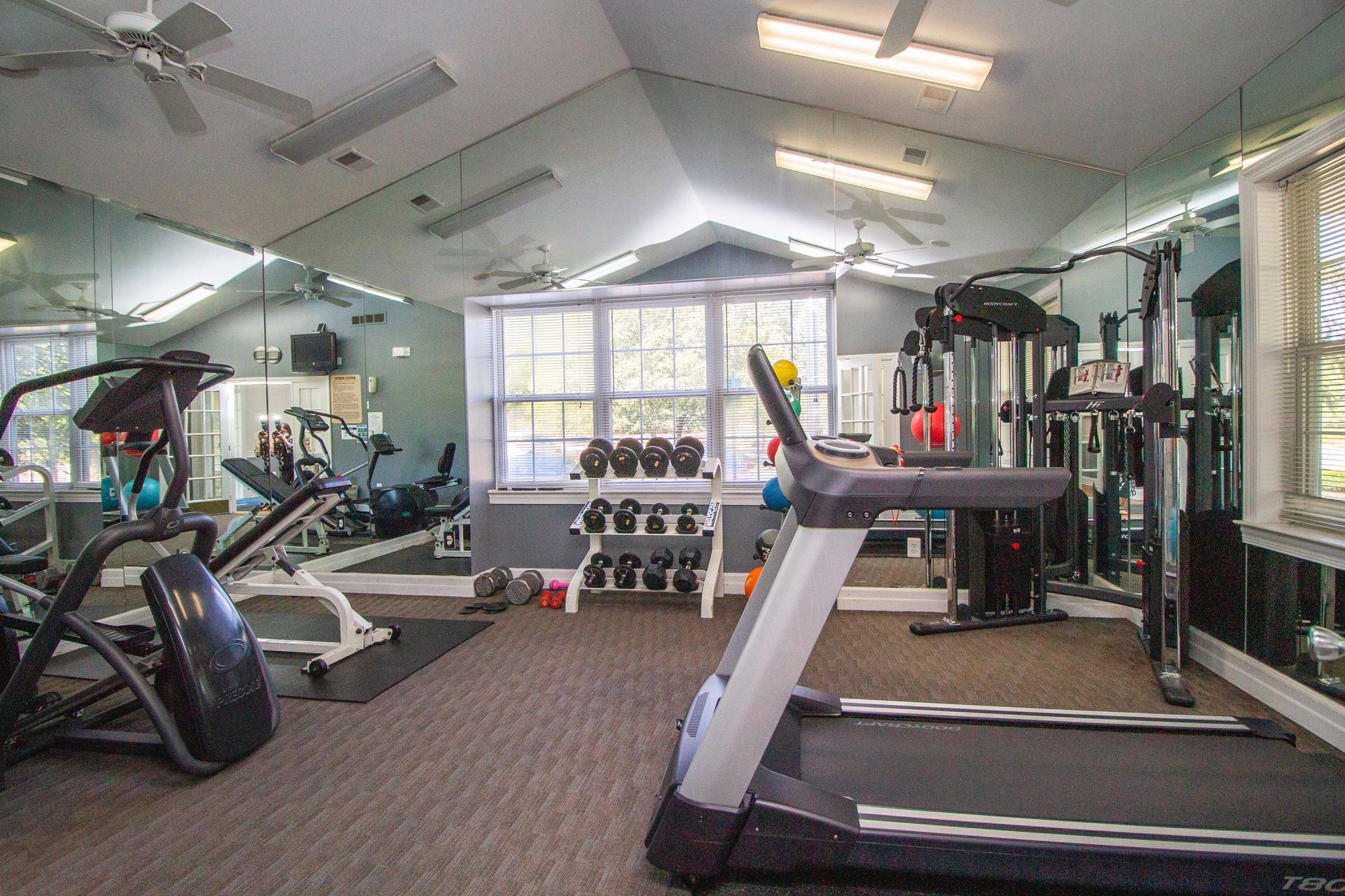 There is a treadmill in the middle of the gym.