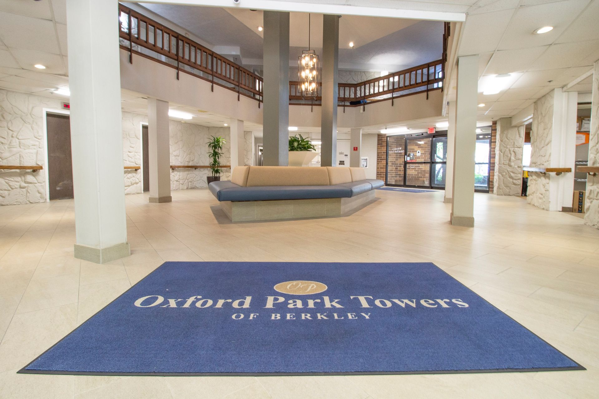 The oxford park towers of berkeley lobby has a blue rug on the floor