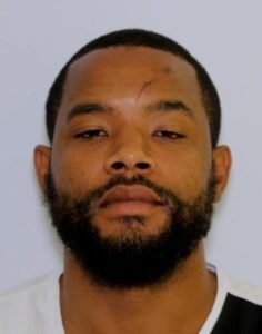 A man with a beard is looking at the camera