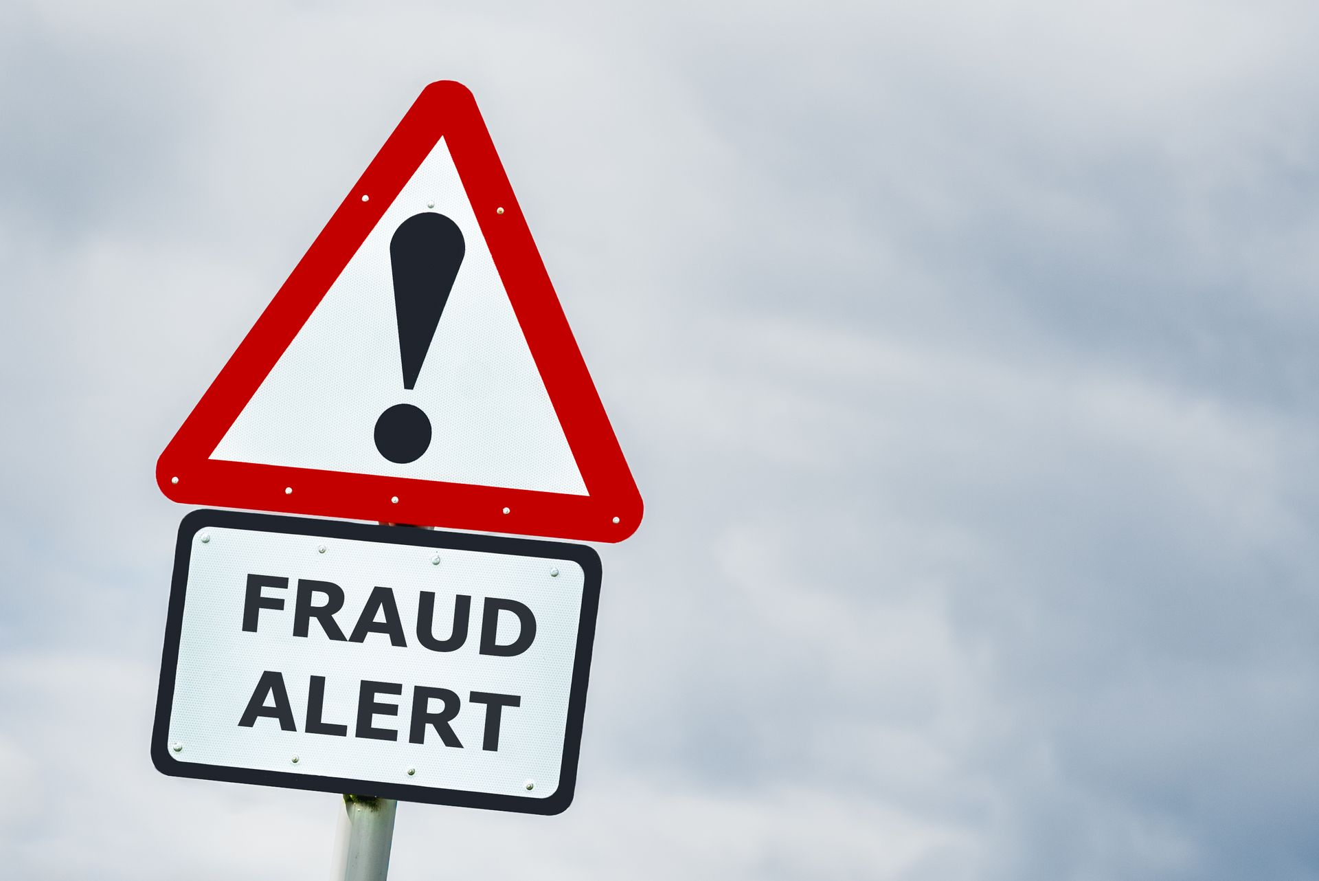 A red and white sign that says fraud alert