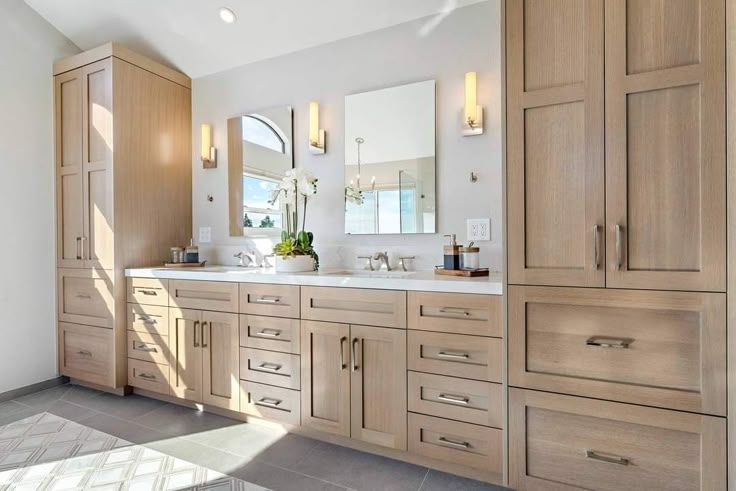 A bathroom with two sinks and a large mirror.