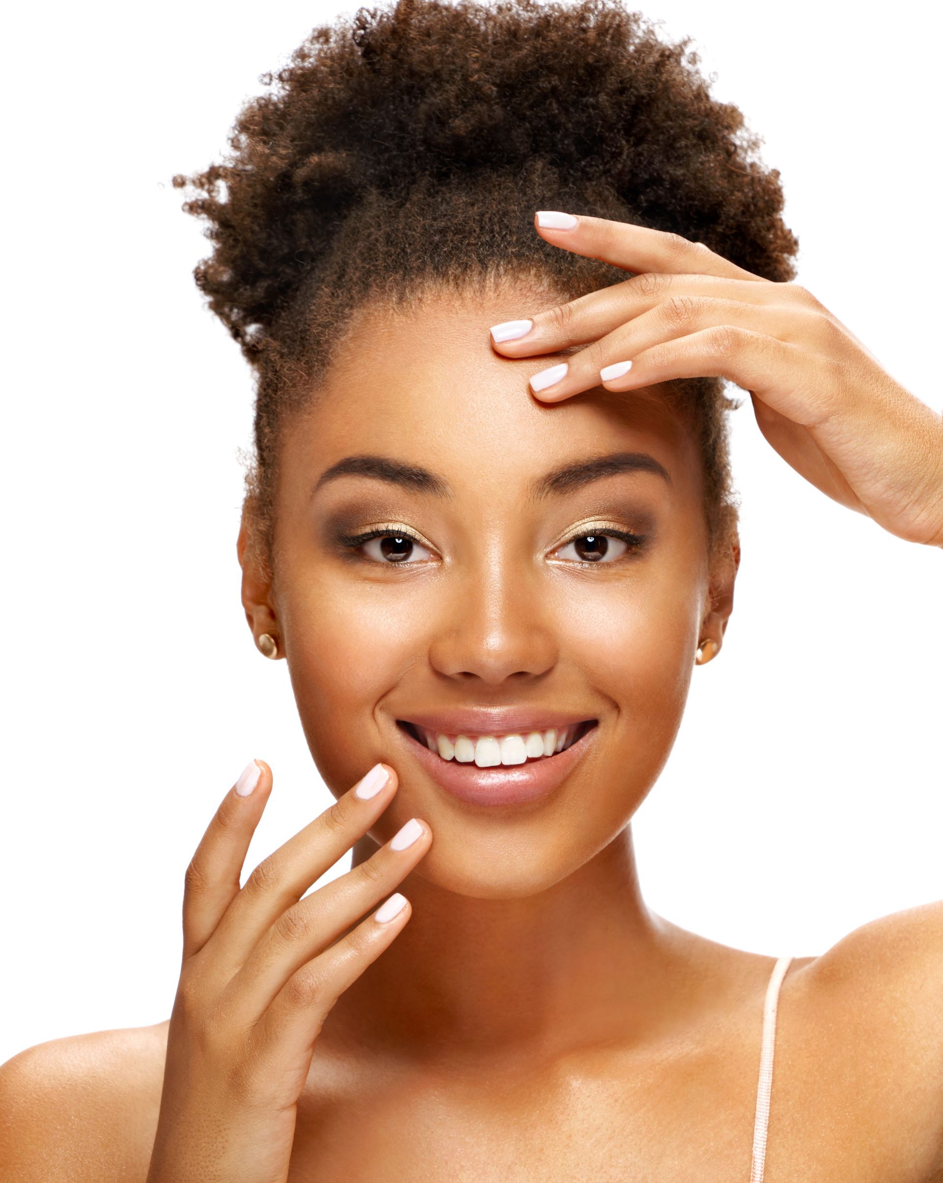 a woman is smiling and touching her face with her hands