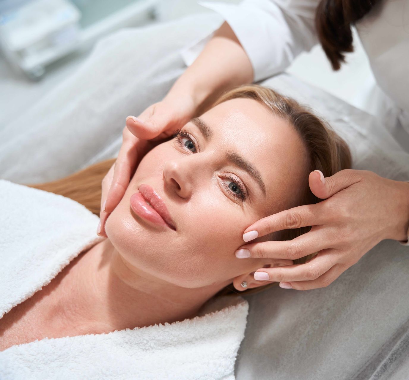 a woman is getting a facial treatment at a beauty salon .